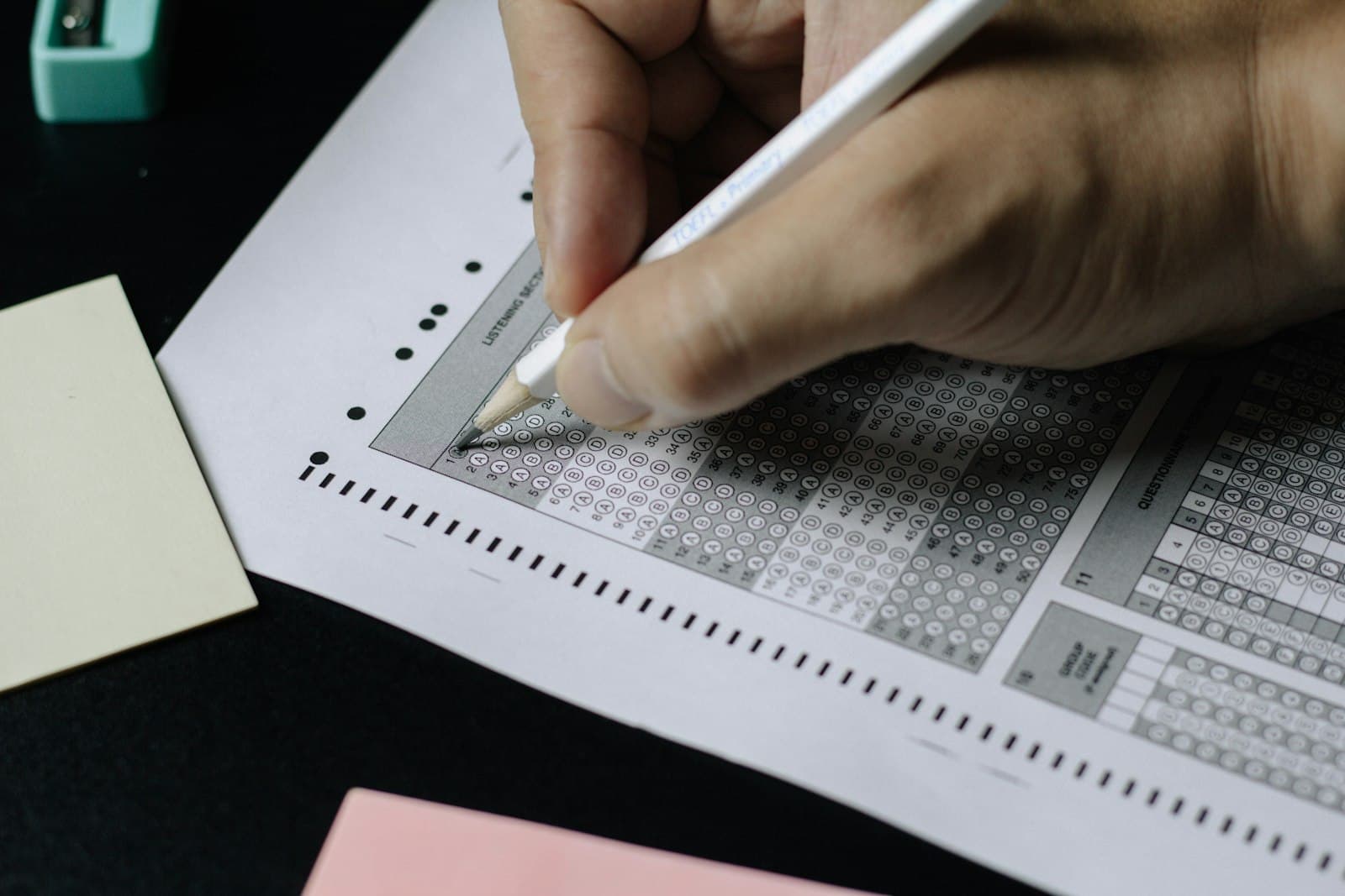 A student filling in a multiple choice answer sheet